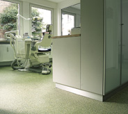 Dental office hallway showing a chair in the background.