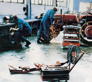 Mechanics put garage flooring durability to the test with welding sparks flying amidst scattered tools.