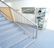 Office hallway and stairs provide calming atmosphere with baby blue floor design.