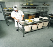 Area cook preps for event on main floor of hotel.