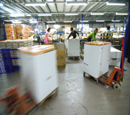 Heavy materials dutifully move across seamless floor by pallet jacks.