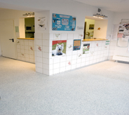 hospital front counter area displays dark grey flooring for patron safety.