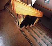 Flaked floor extends to stairs that lead to library.