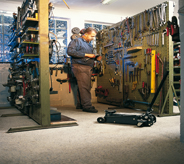 Machinist places materials on shop floor.