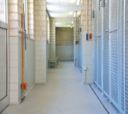 A prison's hall flooring system provides calming light grey color for inmates.