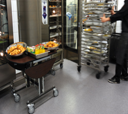 Food cart rolls along restaurant floor.