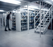 Seamlessly designed dark grey flooring completes a warehouse storage system.