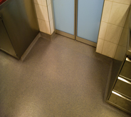 An elevator waiting area floor at a shopping mall.