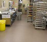 Bakery racks and decorating shelf sits on supermarket floor.