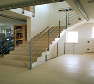 Sun light splashes across uv protected cream colored floor coating of a commercial building.